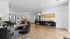 Chic and modern apartment leasing office with elegant decor, featuring sleek black and gold furniture, warm lighting, and stylish wood flooring.