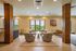 Inviting lounge area with plush chairs, spacious windows showcasing scenic views, and a cozy atmosphere ideal for relaxation.