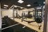Modern gym facility featuring state-of-the-art equipment, spacious workout areas, and sleek contemporary design.