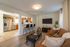Chic open-concept living area with modern kitchen and cozy lounge space, ideal for entertaining.
