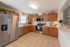 Modern kitchen with stainless steel appliances, warm wooden cabinetry, and elegant decor offering a welcoming and stylish space.