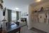 Inviting bedroom with modern decor, featuring a cozy bed, elegant desk workspace, and organized closet space for a stylish lifestyle.