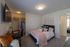 Charming bedroom with cozy bed, elegant decorations, and spacious closet, perfect for a serene retreat.