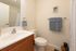 Modern bathroom with sleek fixtures, elegant vanity, and soft blue accents for a tranquil ambiance.
