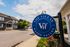 Inviting exterior view of The Villas at Happy Valley, showcasing modern townhouses under a bright blue sky.