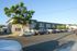 Charming apartment complex with lush greenery, ample parking, and a serene suburban setting.