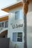 Charming exterior of El Greco apartments with palm tree detail and contemporary architecture.