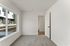 Bright, inviting room with plush carpeting and large window offering plenty of natural light.