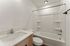 Modern bathroom featuring a sleek sink with a chrome faucet, elegant shower and bathtub combo, and a minimalist design.