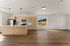 Modern open-concept kitchen with sleek cabinetry and stainless steel appliances, featuring large windows with scenic views and elegant recessed lighting.