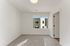 Bright and airy room with large window, new carpet, and modern design offering serene views.