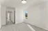 Bright and airy bedroom with large window showcasing stunning mountain views, complemented by fresh carpet and a modern light fixture.