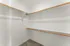 Spacious walk-in closet with abundant shelving and hanging space, perfect for organizing your wardrobe.