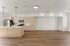 Spacious modern kitchen with sleek light wood cabinetry, stainless steel appliances, and elegant pendant lighting.