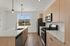 Modern kitchen with sleek appliances, elegant cabinetry, and a stunning view through a large window.
