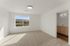 Bright and airy bedroom with mountain views and neutral carpet, featuring an attached bathroom with modern fixtures.