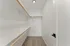 Spacious walk-in closet with organized shelves and ample hanging space.