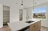 Modern kitchen with sleek countertops, large windows offering scenic mountain views, and ample storage space.