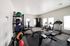 Modern fitness center equipped with state-of-the-art treadmills, exercise bikes, free weights, and strength training machines, all in a bright, well-lit space.