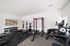 Modern apartment gym featuring state-of-the-art fitness equipment, free weights, and contemporary decor.