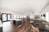 Bright and spacious communal area with modern furnishings, featuring a sleek kitchen, dining tables, and cozy seating arrangements, perfect for gatherings.