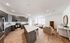 Modern open-concept kitchen and living area with sleek cabinetry, an inviting island, and cozy seating, perfect for entertaining.