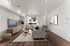 Elegant living room with modern decor, large windows for natural light, cozy seating, and stylish wooden flooring.