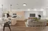 Modern open-concept kitchen and living room with sleek light wood cabinetry, an inviting island, cozy seating, and elegant decor.