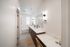 Elegant bathroom with dual sinks, a large mirror, and stylish lighting, highlighting modern design and spaciousness.