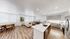 Modern open-concept living space featuring a luxurious kitchen island, sleek cabinetry, and cozy seating area with natural light.
