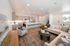Modern open-concept living and kitchen area with stylish furnishings, sleek countertops, and inviting natural light.