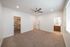 Bright and spacious bedroom featuring plush carpet, ceiling fan, and convenient walk-in closet access.