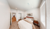 Inviting bedroom with plush carpeting, natural light, and elegant decor for a cozy atmosphere.