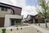 Modern apartment complex with contemporary architecture, featuring stylish facades, large windows, and well-maintained landscaping.