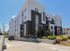 Modern apartment building with sleek design, lush landscaping, and ample natural light, available for leasing.