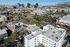 Vibrant urban skyline view showcasing modern high-rises, lush greenery, and bustling streets, ideal for city living enthusiasts.