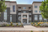 Elegant modern apartment building with a sleek facade, beautifully landscaped entrance, and prominent leasing banner.