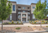 Modern apartment building with clean architectural lines, lush landscaping, and prominent leasing banner.