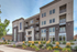 Modern apartment building with sleek balconies and lush landscaping, perfect for contemporary urban living.