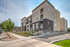 Modern apartment complex with elegant architecture, manicured landscaping, and spacious balconies for a sophisticated urban living experience.