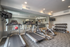 Modern fitness center with state-of-the-art treadmills, exercise bikes, and a well-equipped weight area, perfect for an invigorating workout.