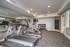 Modern apartment gym with state-of-the-art equipment, including treadmills, exercise bikes, and a full set of dumbbells against a mirrored wall.