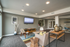 Modern living room featuring sleek furniture, wall-mounted TV, and stylish decor with open layout.