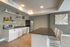 Modern kitchen with sleek countertops, stylish bar seating, and contemporary decor.
