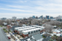 Charming cityscape view showcasing modern townhouses nestled in a vibrant urban neighborhood with scenic mountain backdrop.