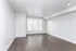 Bright and spacious room featuring sleek hardwood floors, freshly painted walls, and modern recessed lighting.