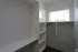 Spacious walk-in closet with natural light, featuring shelves and hanging space for optimized storage.