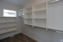 Spacious walk-in closet with custom shelving and abundant natural light.