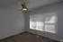 Bright room with modern ceiling fan and large window with blinds, perfect for natural light and comfortable living.