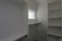 Spacious walk-in closet with sleek shelving and ample natural light.